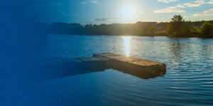 dock at a lake during sunset